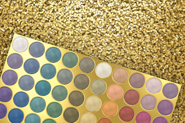 eye shadow in gold palette on gold glitter background