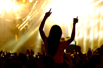 Fans cheering at open-air live concert. Image not in focus