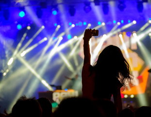 Fan using mobile device for taking pictures, videos or broadcasting at concert