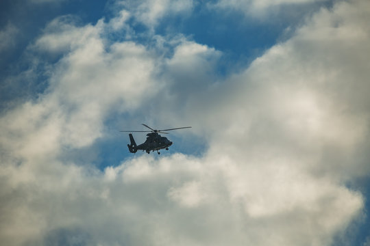 Helicopter flying against the blue sky