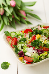 Spring salad with fresh vegetables from radishes and kale