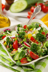 Spring salad with fresh vegetables from radishes and kale