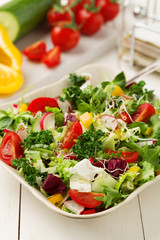 Spring salad with fresh vegetables from radishes and kale