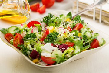 Spring salad with fresh vegetables from radishes and kale