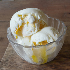 Coconut milk ice cream with frozen egg yolk in glass bowl