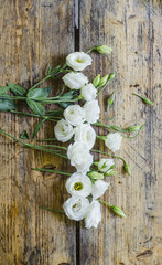 Floral bouquet of roses on a wooden background.