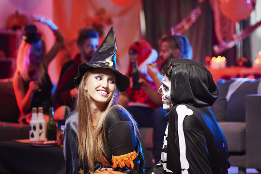 Flirty situation between witch and skeleton