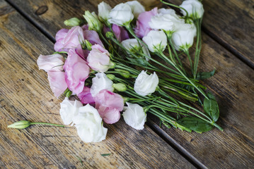 Floral bouquet of roses on a wooden background.