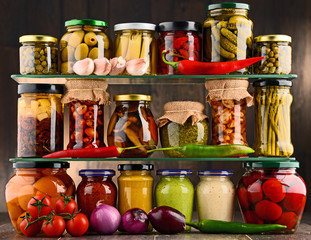 Jars with variety of pickled vegetables.