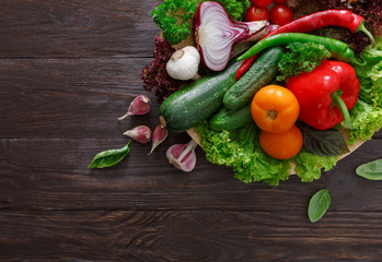 Border of fresh vegetables on wooden background with copy space