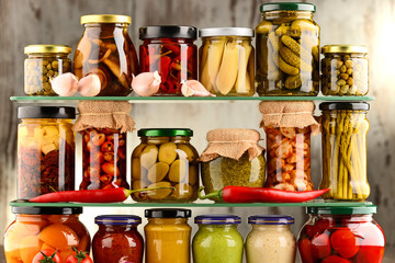 Jars with variety of pickled vegetables.