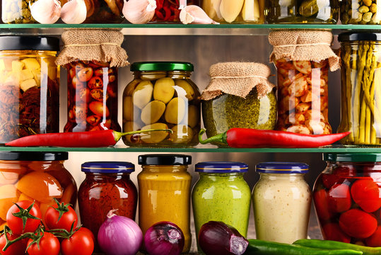 Jars with variety of pickled vegetables.