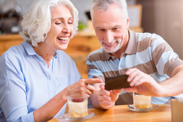 Cheerful senior couple sitting in the cafe