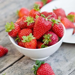 Ripe red strawberries on wooden table