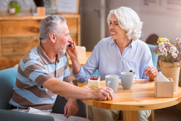 Cheerful senior couple resting in the cafe