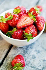 Ripe red strawberries on wooden table