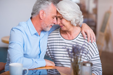 Pleasant loving couple sitting in the cafe