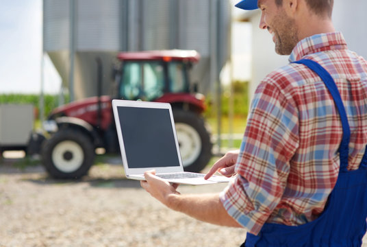 Farmer using laptop on the farm