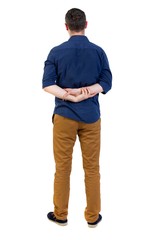 Fototapeta premium Back view of man . Standing young guy. man in a blue shirt with the sleeves rolled up, standing with hands clasped behind his back.