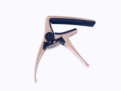 Guitar gold capo on white background , close up