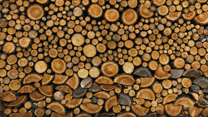 BACKGROUND OF DRY CHOPPED FIRE WOOD LOGS IN A PILE