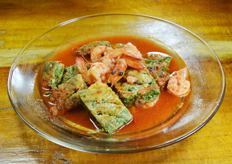 fried egg stuffed climbing wattle and shrimp in spicy sour soup on dish