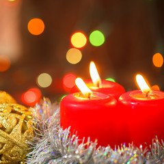 three burning candles and golden balls. Christmas still life
