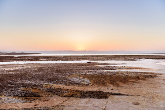 Sunset on salt cristal coastline in Dead Sea, Jordan