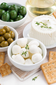 soft cheeses, crackers and pickles for wine, top view