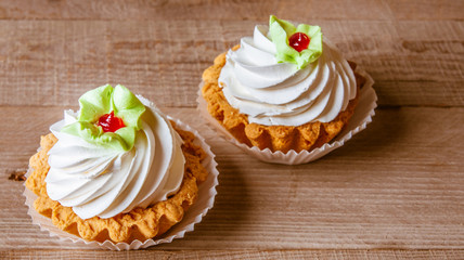 Pink cupcakes on wooden background