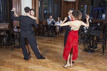 Tango Dancers Performing While Couple Dating In Restaurant