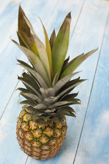 Pineapple on blue wooden board