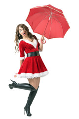 Joyful Santa woman holding umbrella jumping in mid air. Full body length portrait isolated over white studio background.
