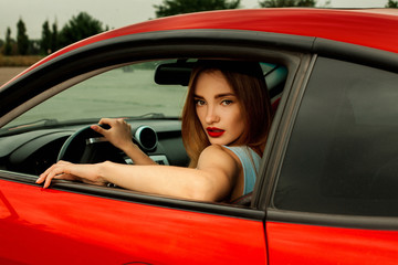 girl with nice makeup driving a red car