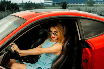 Fototapeta na wymiar beautiful young lady in red car
