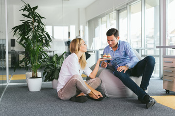 Obraz premium Shot of a two young business people gazing affectionately at each other in office