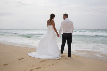 Wedding couple in love in wedding dress on the beach