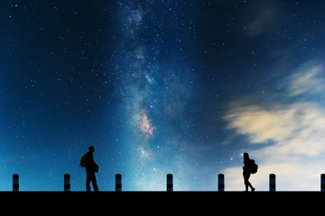Fototapeta premium Galactic beautiful landscapes, travelers on the path that the Milky Way galaxy and the background light of the stars across the night sky.