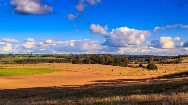 Haystacks after the harvest on the field. 4k timelapse. Mazury - Poland