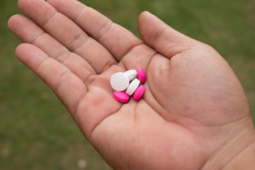 hand holding medicine pills.