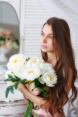 Beautiful girl with a bouquet of white flowers