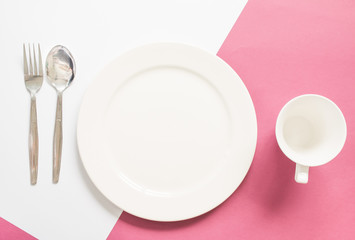 blank white dish with fork and spoon