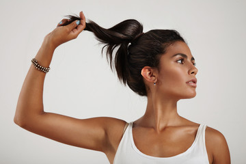 spanish woman holding and pull a ponytail