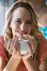 Portrait of smiling woman holding a coffee cup