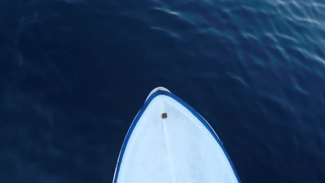 Front of small boat on the blue sea aerial view