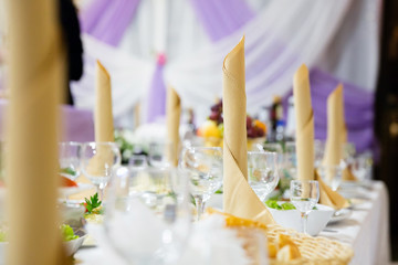 Table in a restaurant with glasses, napkins and cutlery