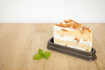 Macadamia cake with Plastic wraps in package on wooden table bac