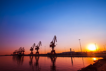 Fototapeta na wymiar In the evening, gantry crane at the dock