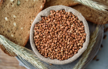 buckwheat in a linen bag on background grain bread