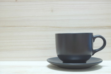 Cup of coffee on wooden background